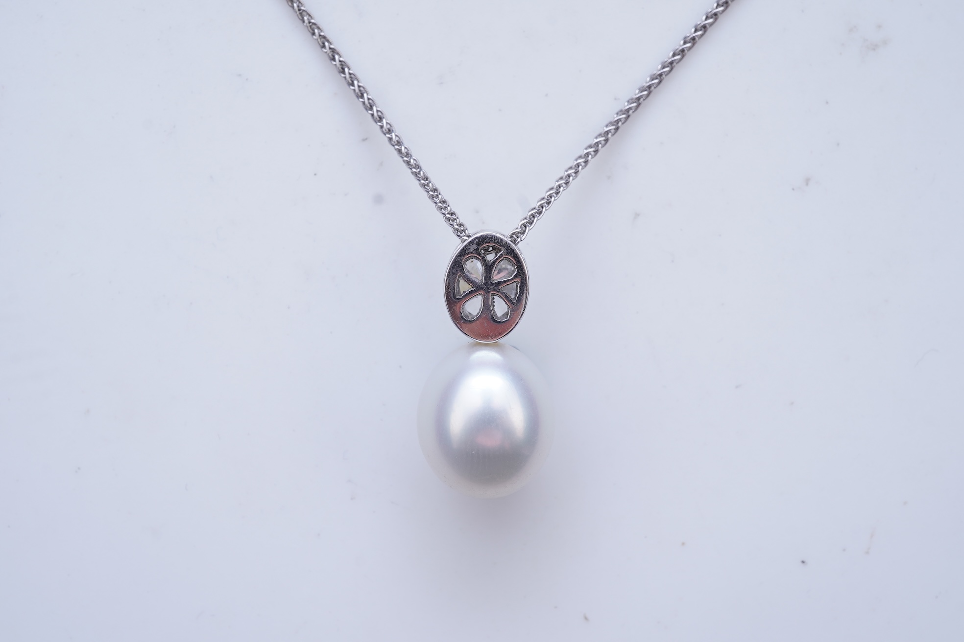 A cultured pearl and diamond pendant